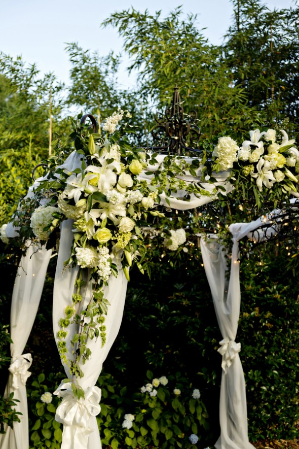 Wedding Arbor Draped in White Flowers and Fabric
